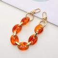 Detail of amber leopard print acrylic phone strap with golden spring ring buckles - K444 Amber