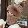 Detail showing the brown knit winter hat with fur pompom and matching fleece-lined neck gaiter - Pineapple Pom Pom / Dark Coffee