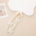 Sweet white pearl phone strap with a butterfly bow charm on a clean beige background - Pearl Bowknot Style (With Bow)