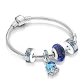 Macro shot of silver octopus charm and blue ocean-themed beads on a snake chain bracelet - A2 / 18cm