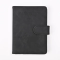 Close-up of black RFID PU leather passport cover with world map and airplane embossing - Black