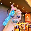 Blue Mickey-shaped acrylic keychain with star sequins, silicone strap, and gold bell - Black Luminous Mickey Head
