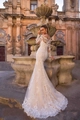 Exquisite close-up of intricate lace embroidery on a white mermaid wedding dress with train - US 2 / Pure White