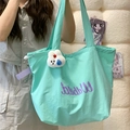 Mint green drawstring tote bag with purple accents and a white plush rabbit pendant - Green with Rabbit Charm