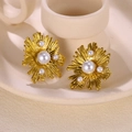 Detailed view of golden sunburst earrings featuring multiple pearls on beige ceramic decor - Starburst Sun Flower Pearl Stud Earrings(G819E5185)
