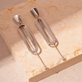 Detail shot of silver double-layer oval geometric earrings on a stone platform - Silver Oval Geometric Earrings