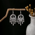Silver ethnic hollow hoop earrings with long leaf tassels hanging on a branch - Silver Hollow Ring Ethnic Tassel Style (E4978)