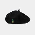 Close-up of a black wool beret featuring a delicate yellow pineapple embroidery detail - One Size / Black