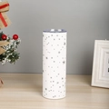 Detail of a 20oz white stainless steel tumbler with silver stars in a holiday setting - Silver Star Pattern