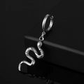 Detailed view of stainless steel snake earring with intricate scales on black mirror - Snake