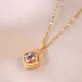 Detailed macro view of gold necklace featuring a square pink crystal and white diamond - Gold Plated Stainless Steel + Zirconia / Pink