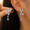 Elegant silver bow drop earrings with sparkling cubic zirconia on a model - Bowknot Water Drop Dangle (A-219)