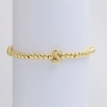 Elastic beaded bracelet in gold with a 18k polished balloon style letter S pendant - Gold S