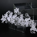 Detail of silver bridal hair comb with pearls and rhinestones on a black background - Style 81256