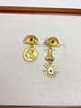 Detail of artistic gold earrings set featuring eye, nose, and coin charms on white canvas - 25 Yellow Evil Eye Asymmetrical Earrings Eh1423
