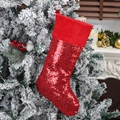Sparkling red sequin Christmas stocking with plush cuff hanging on a festive tree - Red