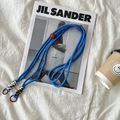 Royal blue braided crossbody bag strap with adjustable rings on white fabric background - Royal Blue Rope Black and White Knot