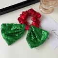 Close-up of a festive red hair scrunchie with a green sequin bow and gold bell detail - Green Sequins Bow