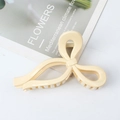 Minimalist cream-colored oversized bow hair claw clip for thick hair styling - Creamy White