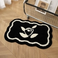 Plush bathroom mat with black and white wave borders and abstract floral design on wood floor - Single Heart-Black