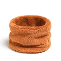 Detail view of the soft coral fleece fabric texture on a warm orange winter neck warmer - Brown
