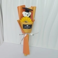 Detail of graduation bear with sunflower bouquet in orange wrap and Best Wishes tag - Orange + Sunflower