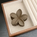 Matte dark brown flower hair claw clip displayed on a minimalist jewelry tray - Matte Five-Petal Flower / Coffee