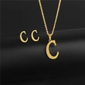 Golden letter C pendant necklace and earrings set on a black minimalist pedestal - Letter C / Gold