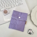 Detailed view of quilted heart pattern and snap button on a purple sanitary storage pouch - Heart Purple