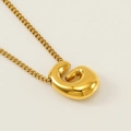 Polished golden stainless steel bubble necklace with an abstract letter E bean pendant - Letter G