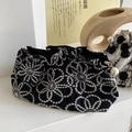 Elegant black embroidered cosmetic bag with floral patterns and a pearl zipper detail - Black Flower