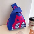 Royal blue knitted wrist bag featuring pink cat pattern and woven texture - Blue - Full Body Cat