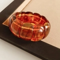 Macro view of amber acrylic stretch bracelet featuring wide geometric linked modules - Dark Coffee