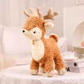Plush Christmas reindeer toy with soft brown fur and golden bell on a lace table - Brown Deer / 30cm