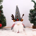 Detail of Christmas gnome with reindeer antlers, gold bell, and textured knit hat - Gray