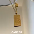 Golden stainless steel necklace featuring a rectangular Cancer zodiac sign pendant - Cancer