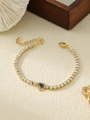 Detail of gold tennis bracelet featuring a blue heart gemstone and clear cubic zirconia - Blue Heart-Shaped Style (ZHB708 Blue)