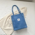 Blue corduroy shoulder bag with double straps and fashion label on white background - Blue