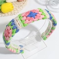 Handmade crochet floral headband with colorful knitted pattern on a display stand - Pink Green Thin Style