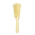 Detail view of the beige detangling hair brush with a flexible hollow vented design - Yellow