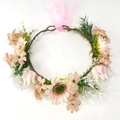 Close-up of artificial sunflower wreath with pink ribbons and delicate silk flowers - Fresh Pink Flower Style