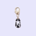 Detailed view of a black and white cat charm with pink paws and a golden heart clasp - Black Cat