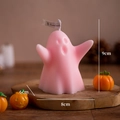 Pink ghost scented candle 9cm tall for Halloween decor on a cozy wooden table - Chubby Pink (White Peach Oolong)