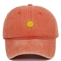 Close-up of yellow sun embroidery on vintage washed cotton baseball cap fabric - Orange