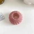 Detailed view of a pink velvet nest-shaped hair claw clip with a soft flocked texture - Flocked Pink
