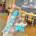 Detail of star-shaped acrylic keychain with colorful beads, blue strap, and golden bell - Blue Colorful Bead Pentagram