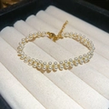 Close-up of double-layer pearl bracelet with gold lobster clasp and adjustable chain - Gold Double Layer Pearl Bracelet / Gold White