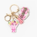 Detailed view of the MOM keychain with pink tassel and floral charm on a gold metal ring - Pink Square MAMA Style