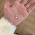 Minimalist silver butterfly necklace with round pearl pendant on wooden background - Hollow Round Pendant with Small Bead Necklace (XL3240)