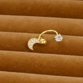 Détail macro du piercing de nombril doré avec pendentif lune en zircon sur velours brun - Style Design Lune (Y20370-2)
